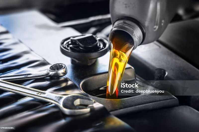 Pour new automotive engine oil into the engine(deepblue4you)