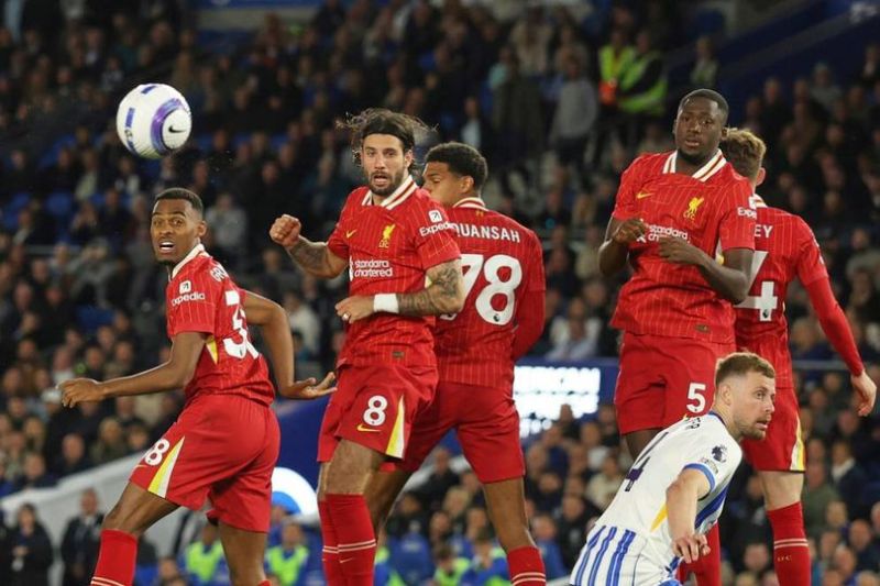 Pemain Liverpool Dominik Szoboszlai (tengah) menyundul bola dalam pertandingan Premier League melawan Brighton, Selasa (20/5/2025). (c) AP Photo/Ian Walton
