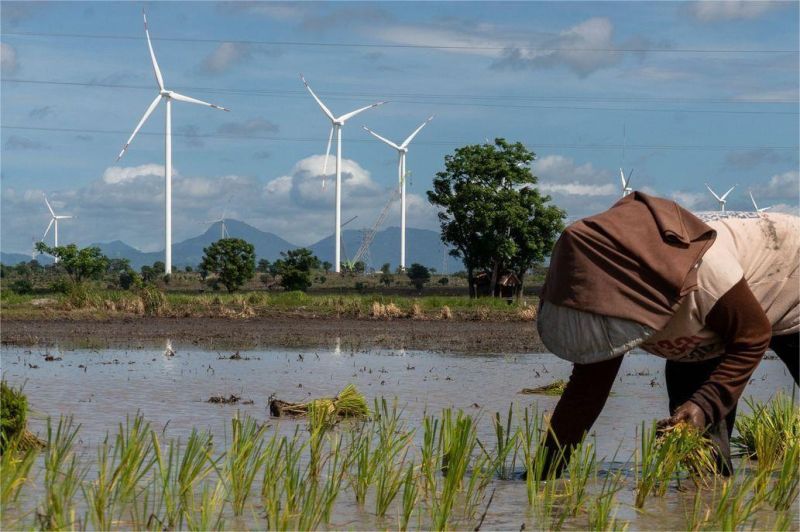 ilustrasi ladang turbin angin dan panel surya di wilayah terbuka