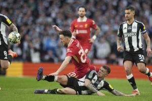 Diogo Jota dijegal Kieran Trippier di laga Liverpool vs Newcastle di final Carabao Cup di Wembley, Minggu (16/3/2025). (c) AP Photo/Alastair Grant