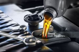 Pour new automotive engine oil into the engine(deepblue4you)
