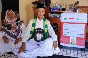 Rahman (71) warga desa-kecamatan Kramatmulya Kabupaten Kuningan Jawa Barat menunjukan koper dan kain ihram yang akan dibawanya pergi hari tahun ini, Kamis (1/5/2025) siang.(KOMPAS.com)