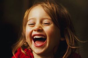 anak kecil perempuan yang sedang tertawa bahagia